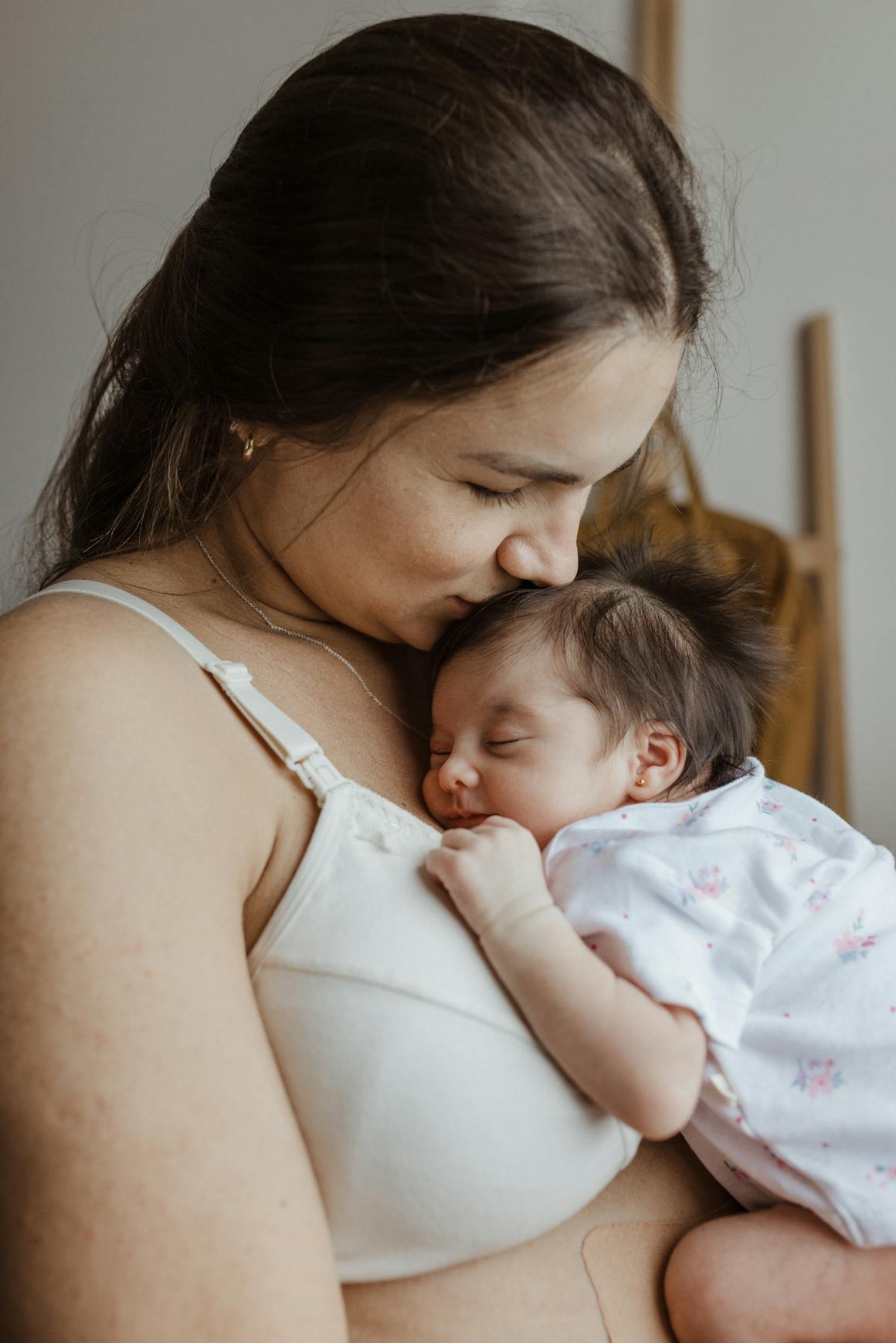 A woman holding a baby in her arms while breastfeeding